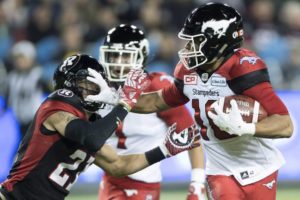 Calgary Stampeders slotback Marquay McDaniel fends off Ottawa Redblacks cornerback Mitchell White during first quarter CFL Grey Cup action, Sunday, November 27, 2016 in Toronto. (Photo credit: THE CANADIAN PRESS/Ryan Remiorz)